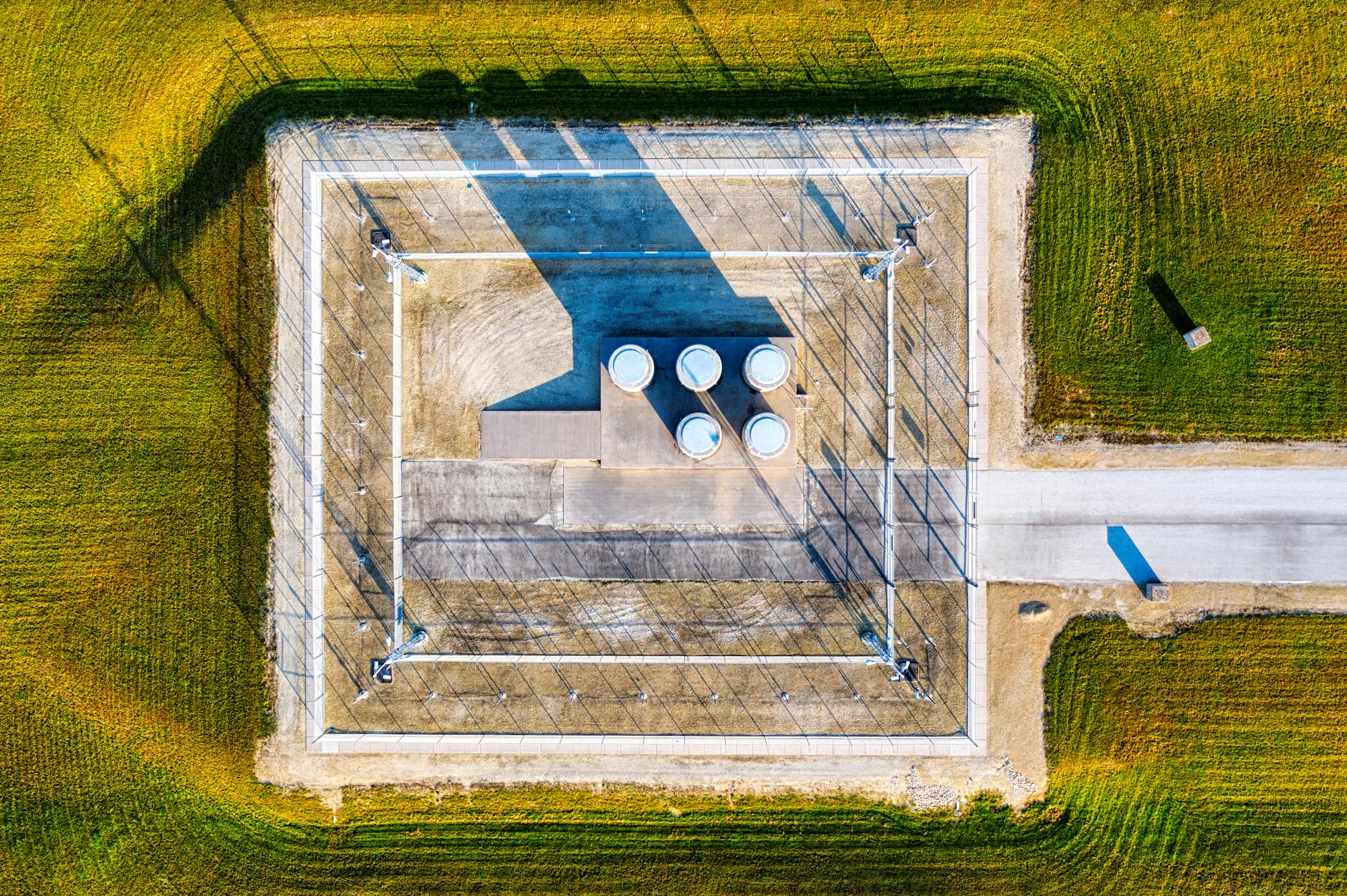top view of an industrial area surrounded by green grass